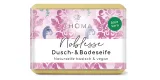 rechteckige, cremefarbene Seife mit pink-lilafarbener Verpackung und Aufschrift Noblesse, feine Sheabutterseife vegan von der Naturseifen Manufaktur Uckermark.
